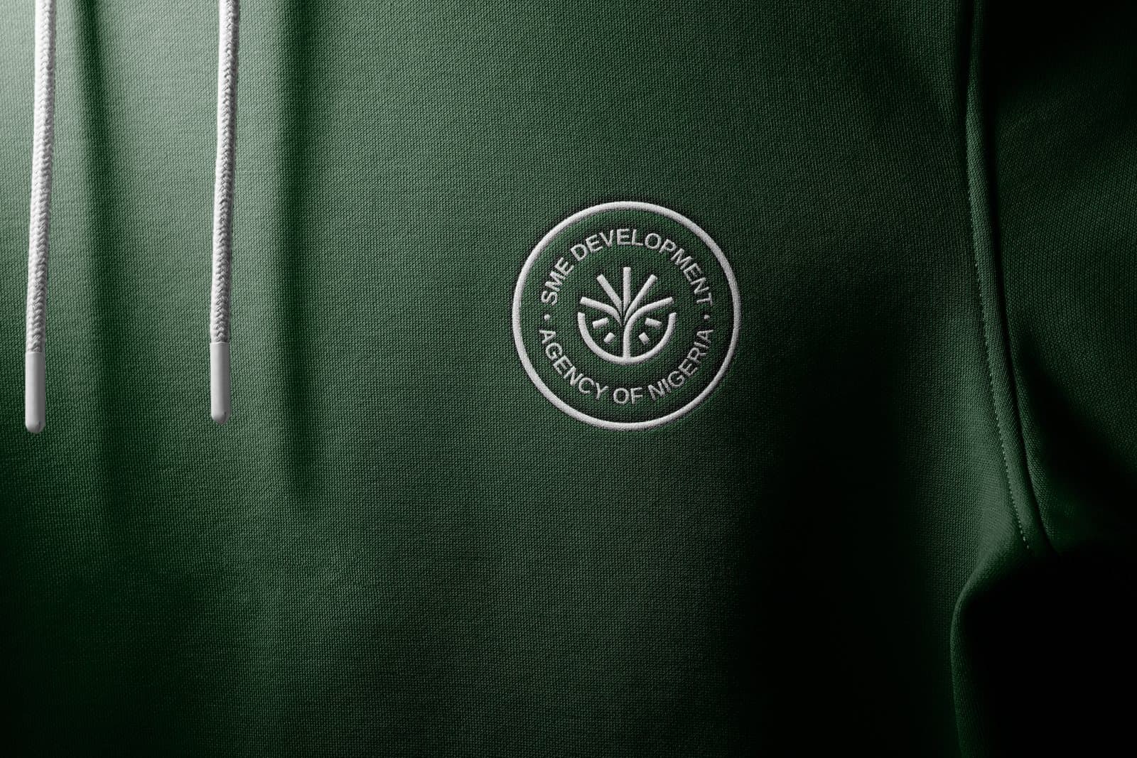 The SMEDAN seal embroidered on a green hoodie